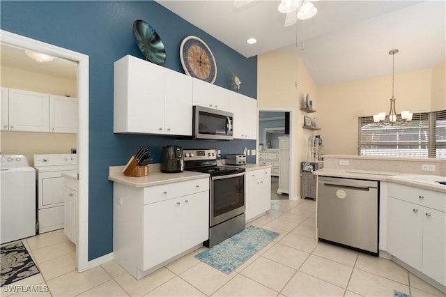 kitchen featuring stainless steel appliances, washer and dryer, a ceiling fan, light countertops, and high vaulted ceiling
