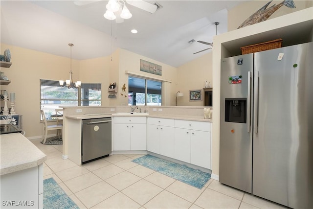 kitchen featuring stainless steel appliances, ceiling fan, light countertops, white cabinets, and a chandelier