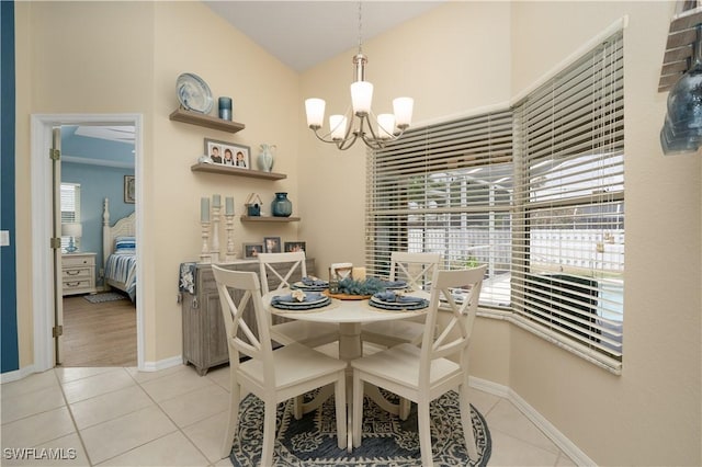 dining area featuring a chandelier, light tile patterned floors, and baseboards