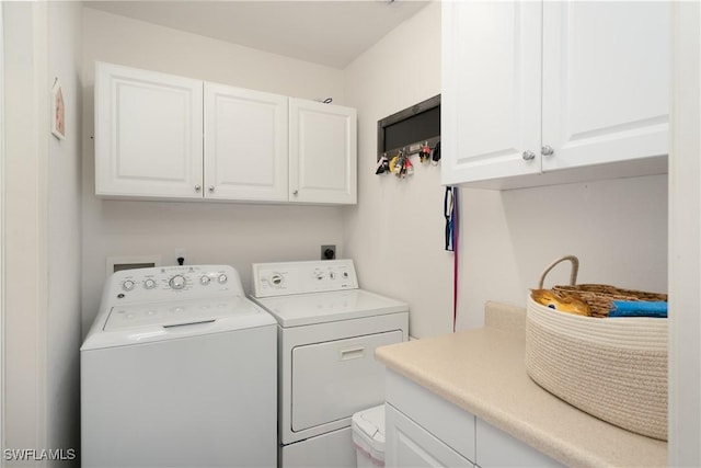laundry room featuring separate washer and dryer and cabinet space