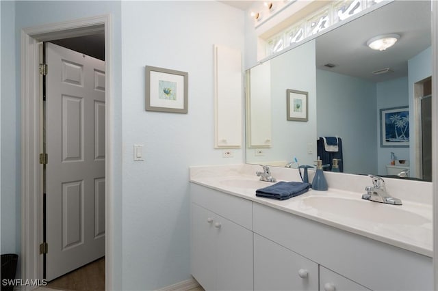 bathroom with double vanity and toilet