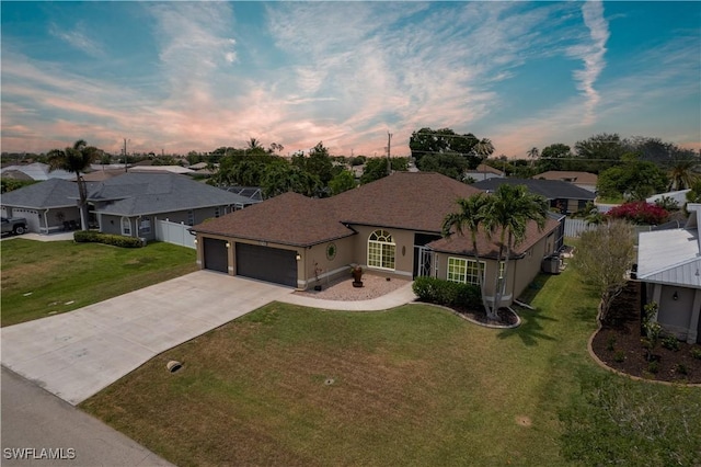 view of front of house featuring a garage, concrete driveway, a residential view, and a shingled roof