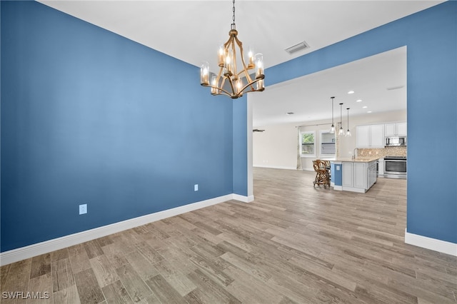 10626 Essex Square Blvd, Fort Myers, FL 33913 - unfurnished room with a chandelier, light wood-type flooring, a sink, baseboards, and recessed lighting