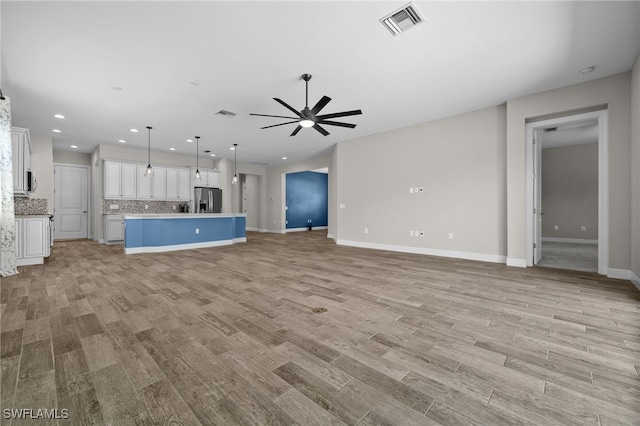 10626 Essex Square Blvd, Fort Myers, FL 33913 - unfurnished living room with a ceiling fan, light wood finished floors, baseboards, and recessed lighting
