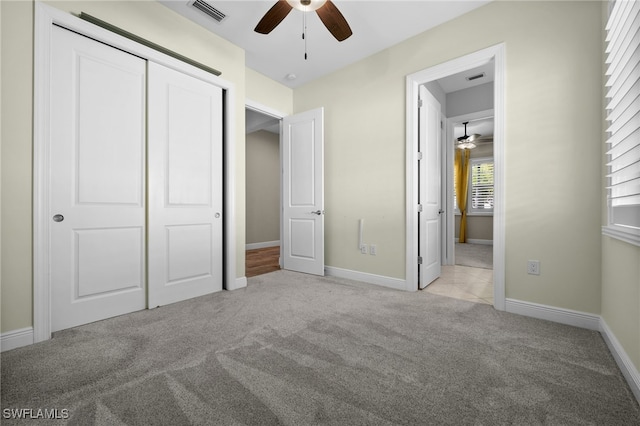 10626 Essex Square Blvd, Fort Myers, FL 33913 - unfurnished bedroom featuring light colored carpet, a closet, baseboards, and a ceiling fan