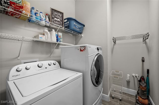 10626 Essex Square Blvd, Fort Myers, FL 33913 - laundry room with washer and clothes dryer, wood finished floors, and baseboards