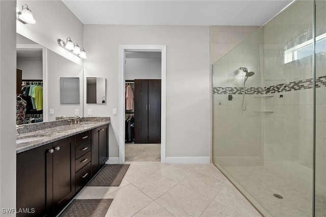 10626 Essex Square Blvd, Fort Myers, FL 33913 - full bath with a tile shower, double vanity, baseboards, and tile patterned flooring