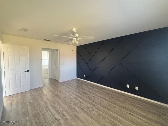 3408 SW 17th Pl, Cape Coral, FL 33914 - spare room with ceiling fan, wood finished floors, and baseboards