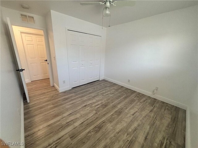 3408 SW 17th Pl, Cape Coral, FL 33914 - unfurnished bedroom with wood finished floors, baseboards, and a closet