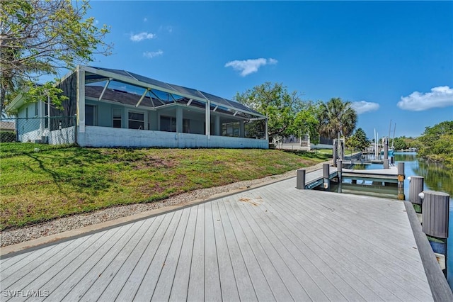1976 San Marco Rd, Marco Island, FL 34145 - dock featuring a water view, a yard, a lanai, and boat lift