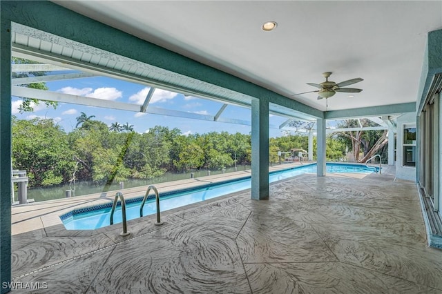 1976 San Marco Rd, Marco Island, FL 34145 - outdoor pool with a ceiling fan, view of scattered trees, a patio, and a lanai