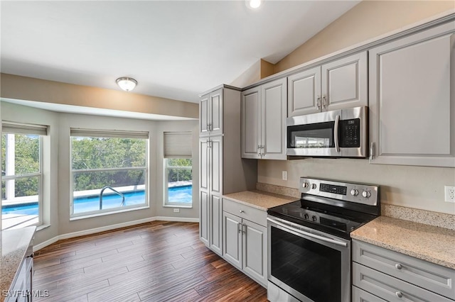 1976 San Marco Rd, Marco Island, FL 34145 - kitchen featuring stainless steel appliances, gray cabinets, light stone countertops, and dark wood-style flooring