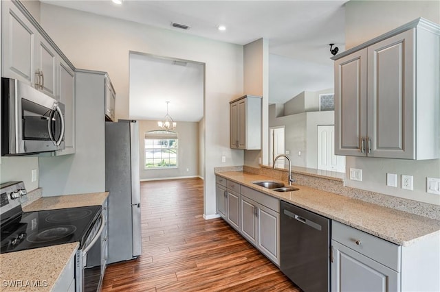 1976 San Marco Rd, Marco Island, FL 34145 - kitchen with appliances with stainless steel finishes, gray cabinets, dark wood-type flooring, lofted ceiling, and a chandelier
