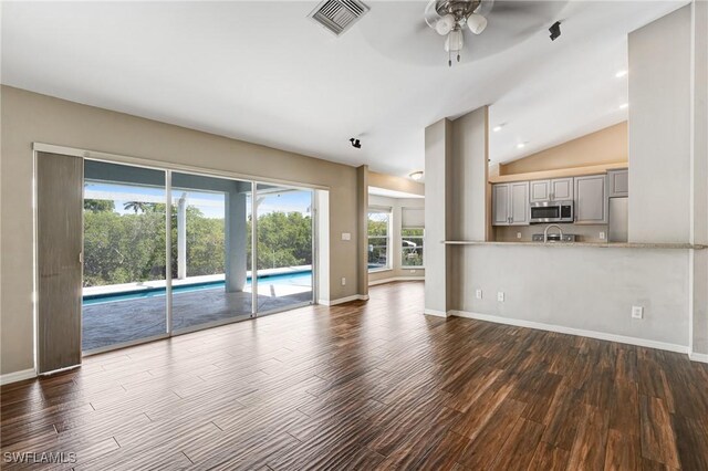 1976 San Marco Rd, Marco Island, FL 34145 - unfurnished living room with ceiling fan, dark wood-style flooring, and lofted ceiling