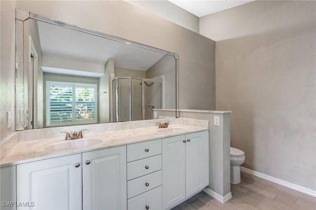 1976 San Marco Rd, Marco Island, FL 34145 - bathroom featuring double vanity, a shower stall, and wood finished floors