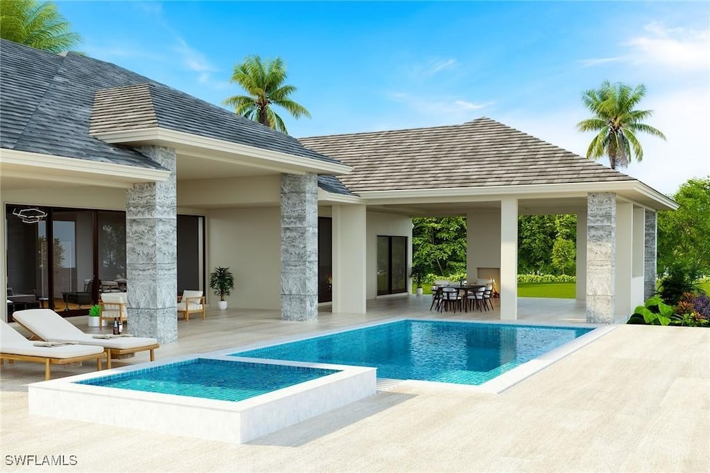 view of pool featuring a patio, a pool with connected hot tub, and outdoor dining space