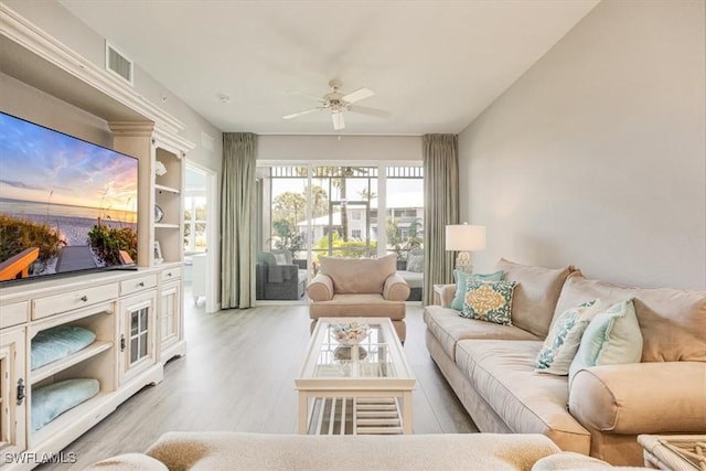living room with a ceiling fan and wood finished floors