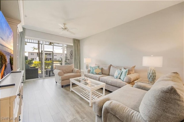 living area with a ceiling fan and light wood-style floors