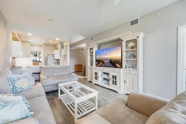 living area with wood finished floors and recessed lighting