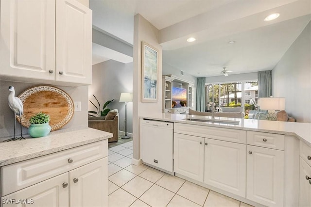kitchen with white dishwasher, open floor plan, a sink, light tile patterned floors, and a ceiling fan