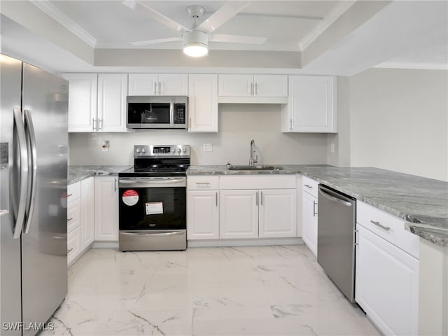 4280 SE 20th Pl Unit 207, Cape Coral, FL 33904 - kitchen with stainless steel appliances, a sink, white cabinets, a ceiling fan, and crown molding