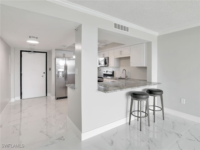 4280 SE 20th Pl Unit 207, Cape Coral, FL 33904 - kitchen featuring stainless steel appliances, a sink, baseboards, light marble finish flooring, and crown molding