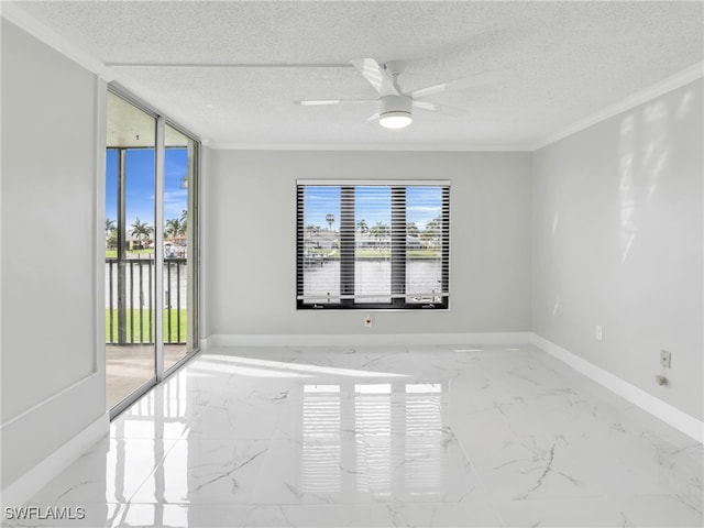 4280 SE 20th Pl Unit 207, Cape Coral, FL 33904 - spare room featuring marble tiled flooring, healthy amount of natural light, baseboards, a textured ceiling, and ornamental molding