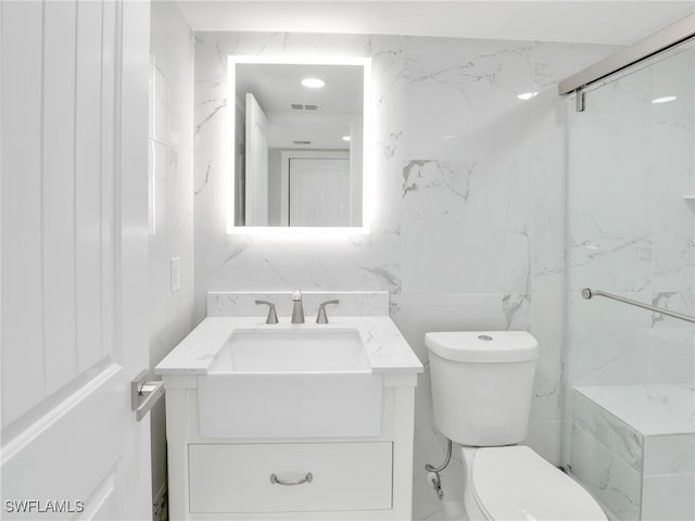 4280 SE 20th Pl Unit 207, Cape Coral, FL 33904 - bathroom with vanity, toilet, and tile walls