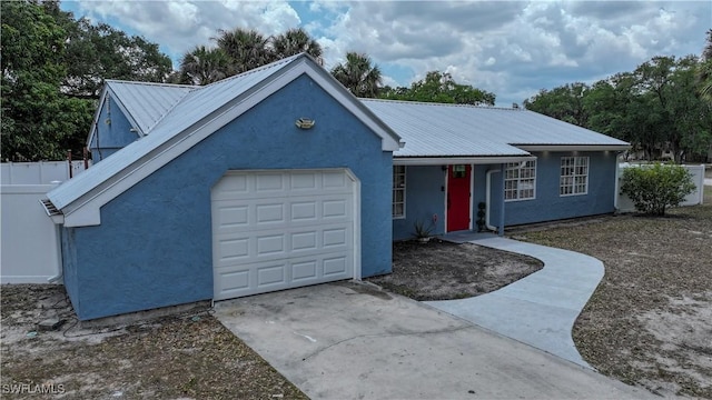 4002 Cascade Ln, Labelle, FL 33935 - ranch-style house with concrete driveway, stucco siding, metal roof, and an attached garage