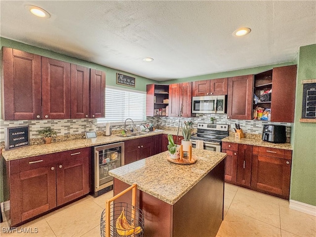 4002 Cascade Ln, Labelle, FL 33935 - kitchen with open shelves, appliances with stainless steel finishes, wine cooler, backsplash, and a sink