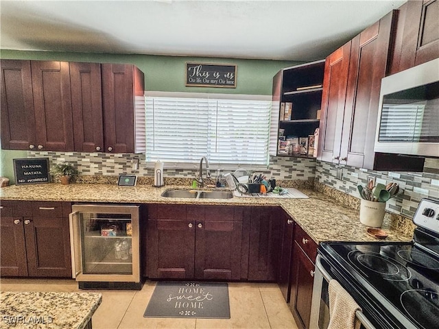 4002 Cascade Ln, Labelle, FL 33935 - kitchen featuring appliances with stainless steel finishes, wine cooler, a sink, and decorative backsplash