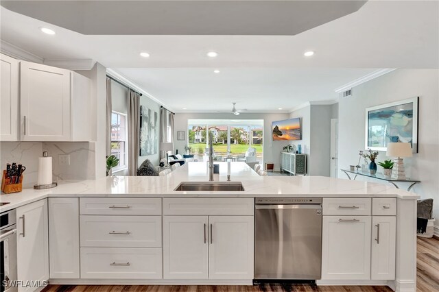 3580 Windjammer Cir Unit 1603, Naples, FL 34112 - kitchen featuring stainless steel appliances, recessed lighting, crown molding, white cabinets, and a sink