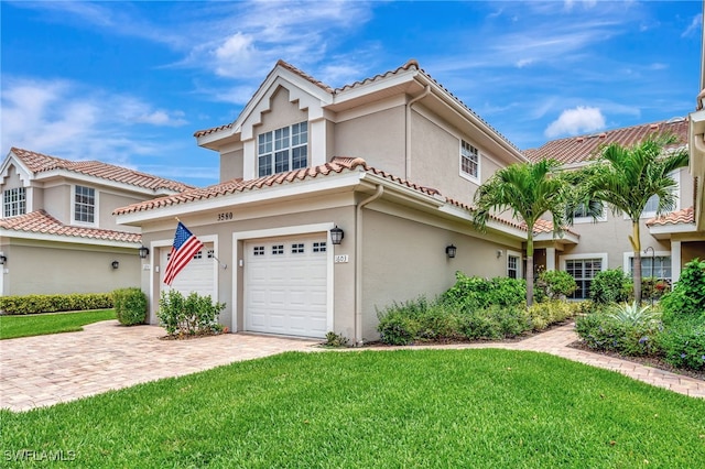 3580 Windjammer Cir Unit 1603, Naples, FL 34112 - mediterranean / spanish-style home with stucco siding, a front lawn, decorative driveway, and a tile roof