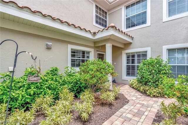 3580 Windjammer Cir Unit 1603, Naples, FL 34112 - view of exterior entry featuring stucco siding