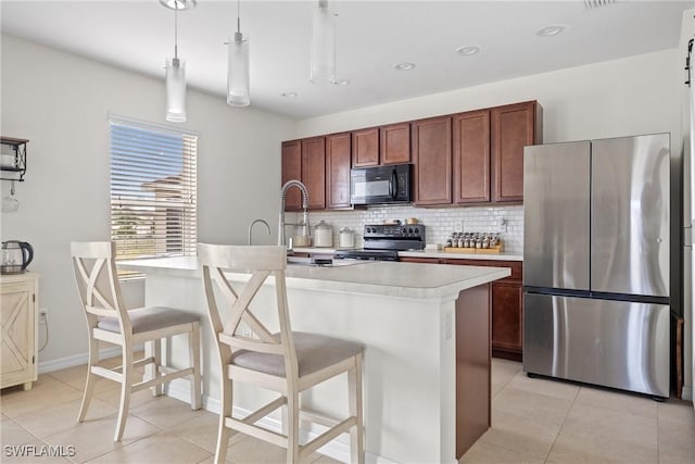 8118 Gopher Tortoise Trl, Lehigh Acres, FL 33972 - kitchen featuring appliances with stainless steel finishes, light countertops, backsplash, light tile patterned floors, and a breakfast bar