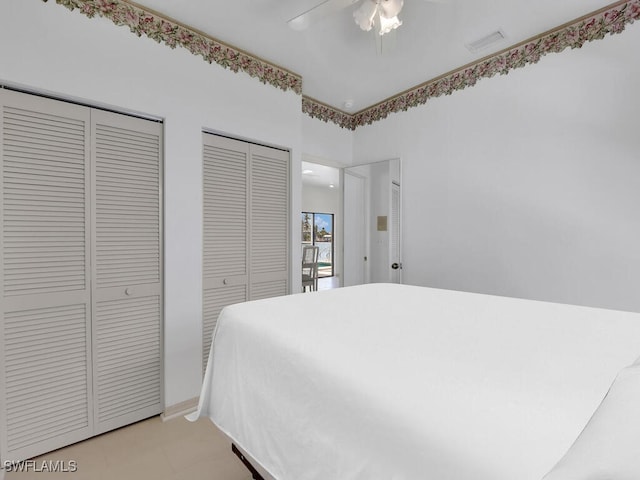bedroom featuring two closets and ceiling fan