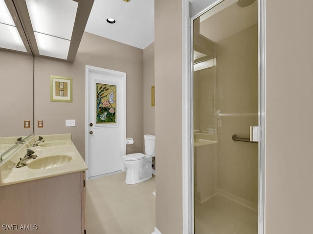 full bath featuring toilet, a shower stall, and double vanity