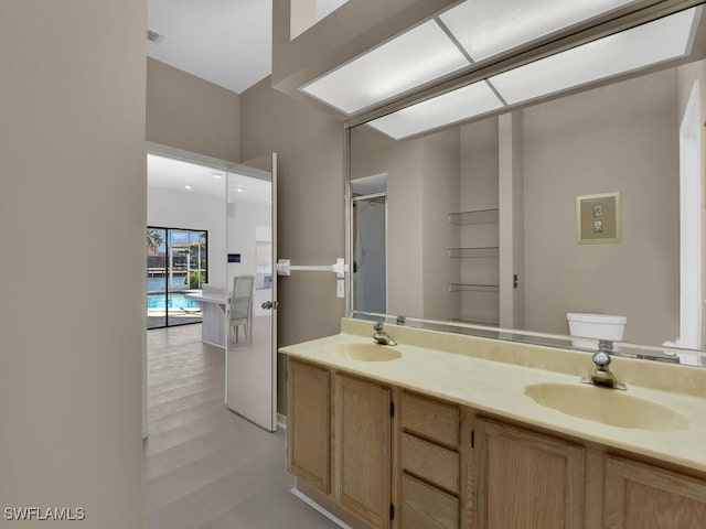 bathroom featuring double vanity and toilet