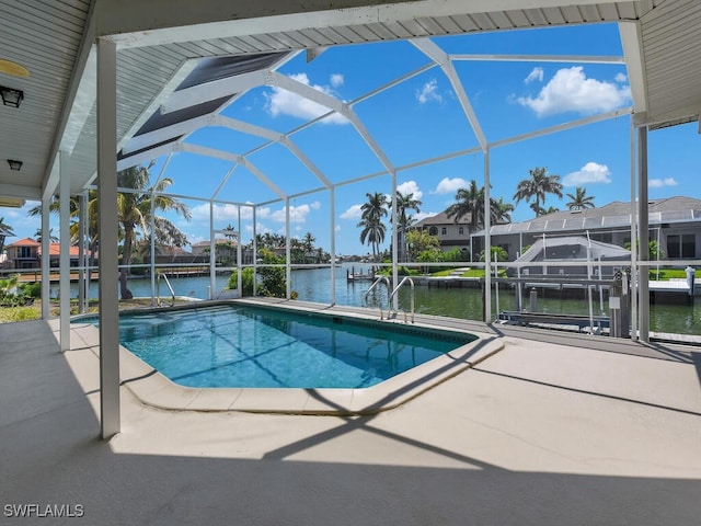 swimming pool with a boat dock, a water view, a patio, glass enclosure, and boat lift