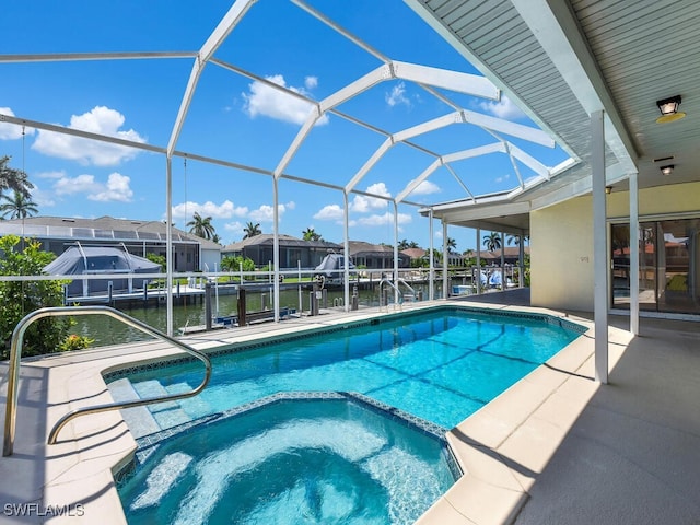 view of swimming pool with a pool with connected hot tub, boat lift, a boat dock, a water view, and glass enclosure