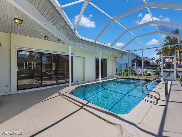 swimming pool featuring a patio area and glass enclosure