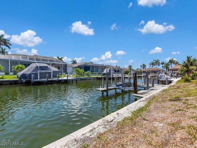 dock featuring boat lift, a residential view, and a water view