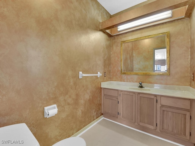 bathroom with toilet and vanity
