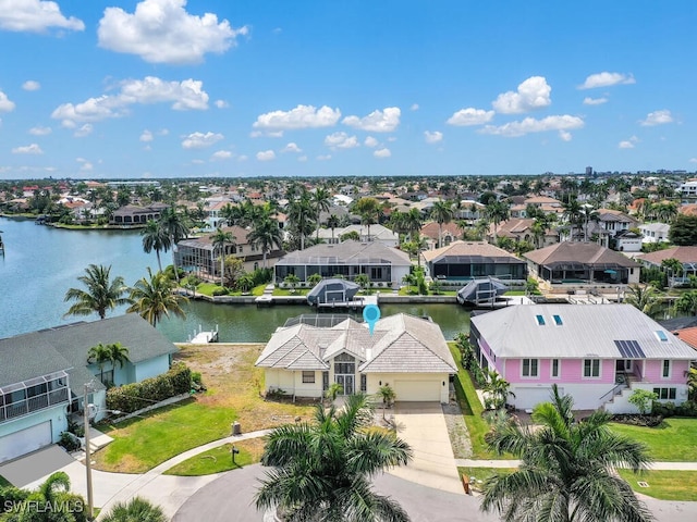 aerial view of residential area featuring a nearby body of water