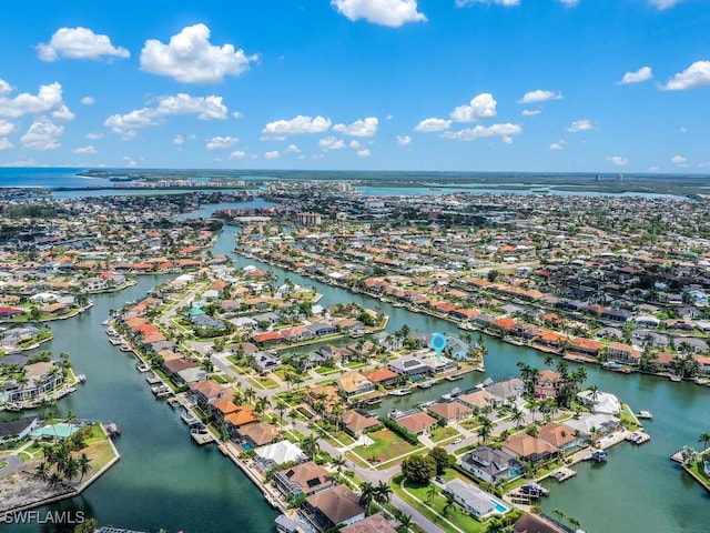 view of property location featuring a large body of water and nearby suburban area