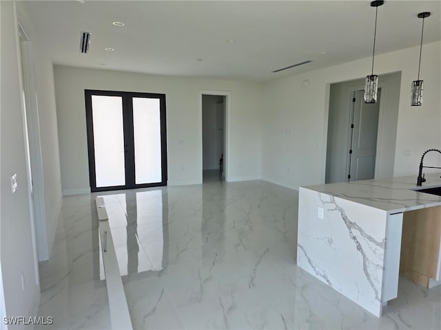 spare room with light marble finish flooring, baseboards, recessed lighting, and a sink