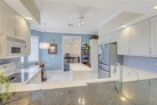 kitchen with white appliances, a ceiling fan, backsplash, a sink, and ornamental molding