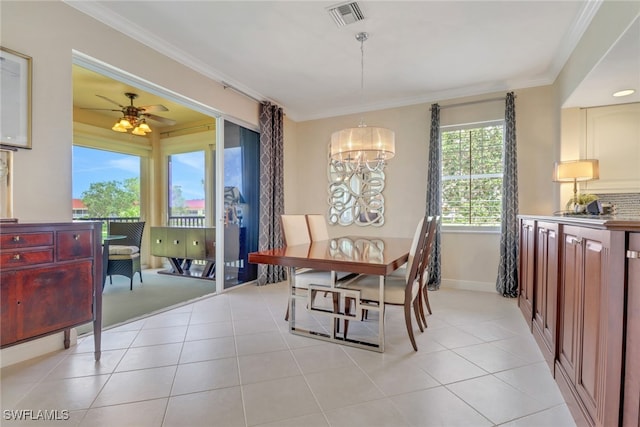 dining space featuring light tile patterned floors, crown molding, ceiling fan, baseboards, and a chandelier