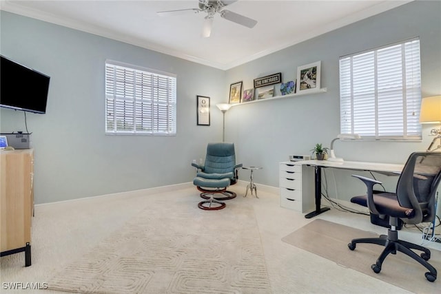 carpeted home office featuring crown molding, ceiling fan, plenty of natural light, and baseboards