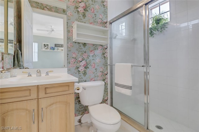 full bath with wallpapered walls, healthy amount of natural light, a shower stall, and vanity
